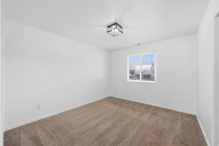 Bedroom 2 Neutral tone walls with coordinating carpet