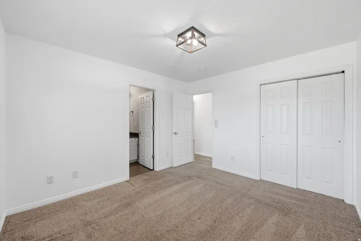 Master Bedroom featuring white walls, white trim, and a contemporary flush-mount light fixture