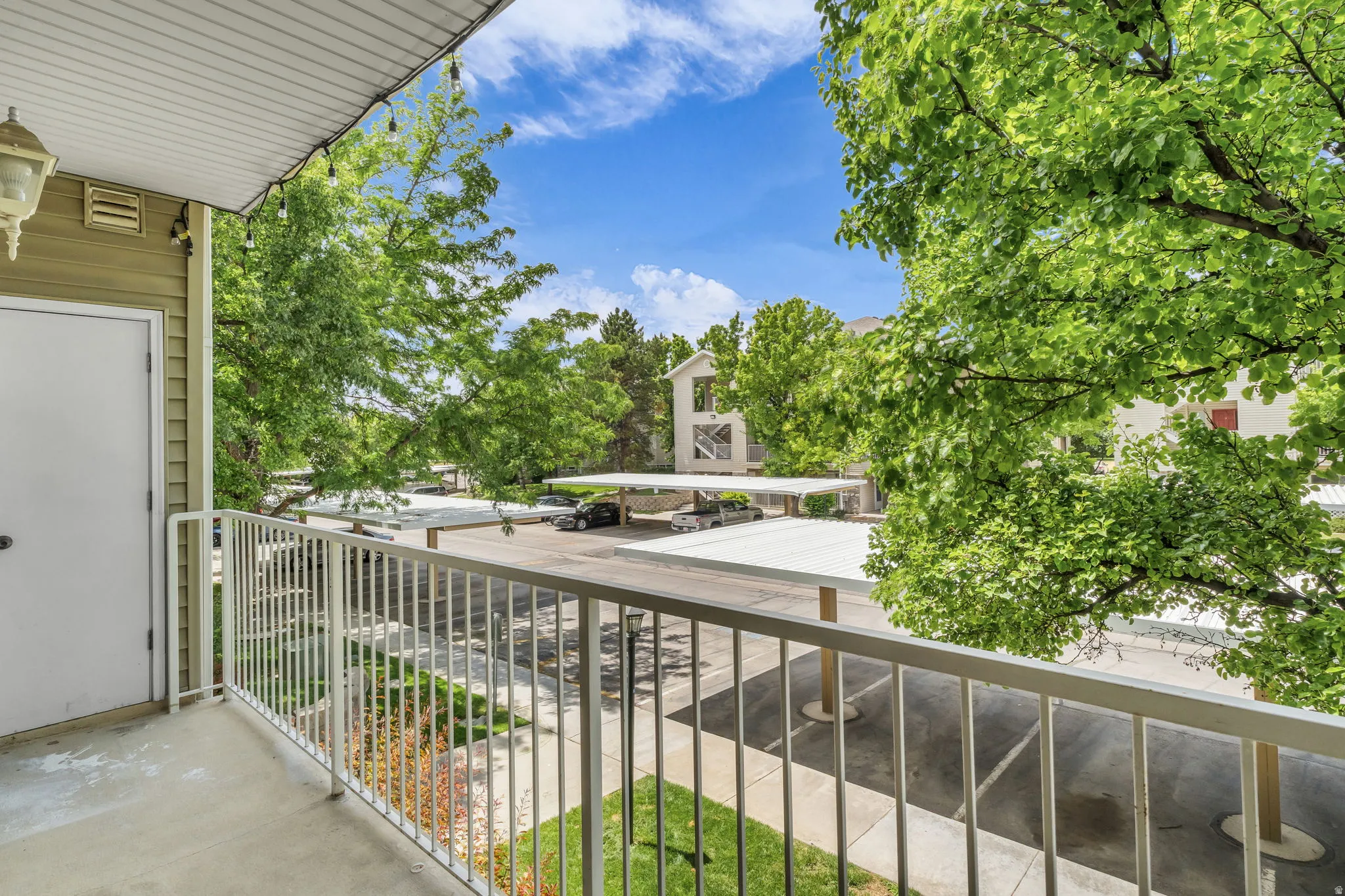 Balcony with a white metal railing and a concrete floor