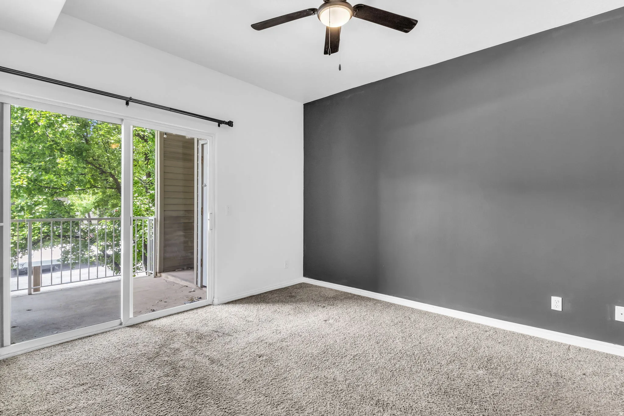 Interior room featuring a sliding glass door opening to a private balcony