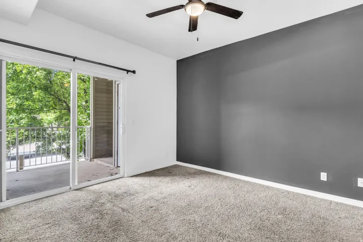 Interior room featuring a sliding glass door opening to a private balcony