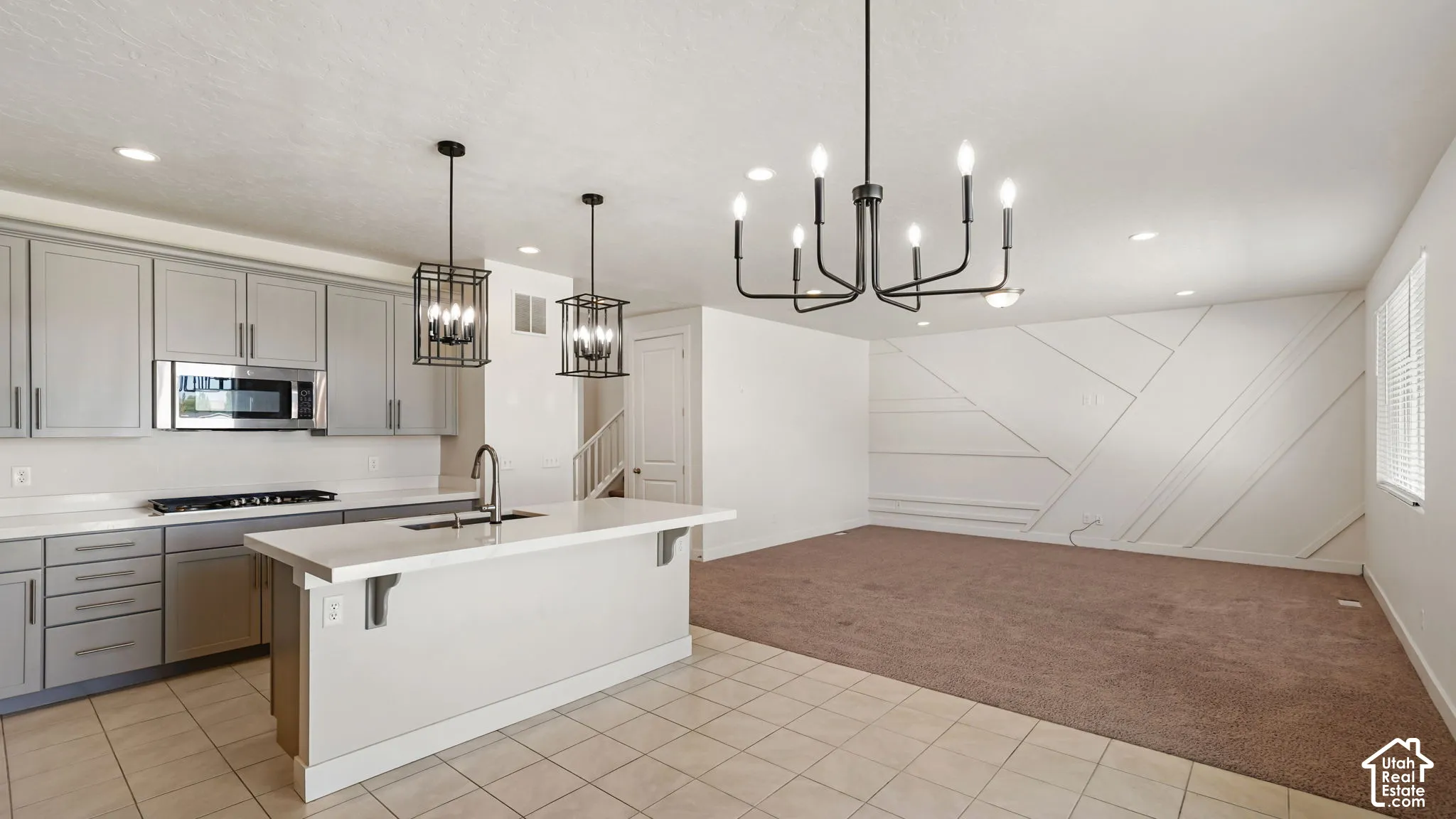 Kitchen featuring a center island, pendant lighting, stainless steel appliances, Farmhouse sink including a Gas Cooktop and shaker-style cabinetry