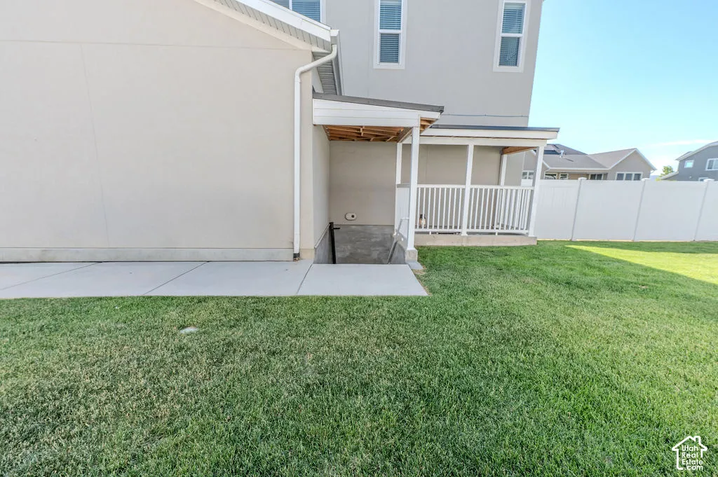 BRILLIANT fenced entrance to the ADU w/ a covered concrete patio and a privacy fence