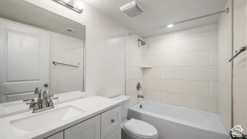 ADU ensuite Bathroom-1 of 2 Bathrooms in ADU--  with White Quartz vanity with integrated sink, brushed nickel faucet, large wall mirror, white subway tile shower surround, and integrated bathtub