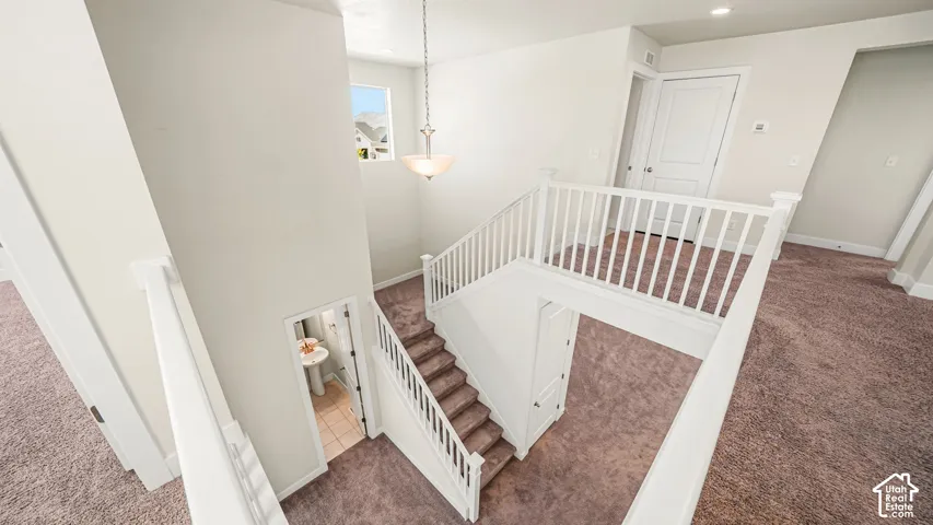Dramatic Stairwell featuring white ballustrades
