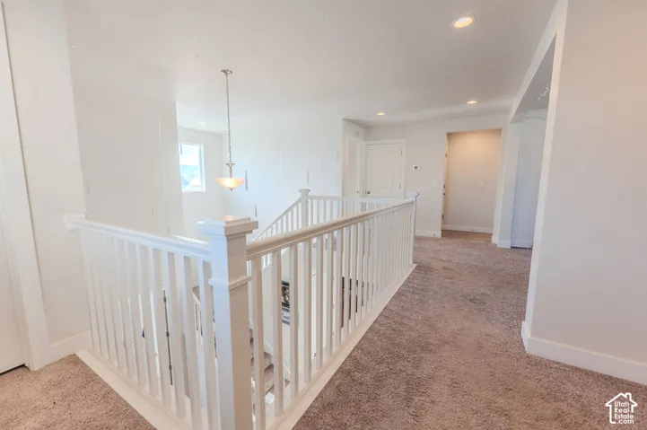 Gorgeous balustrade staircase looking down into main level