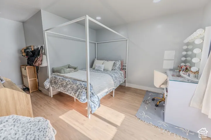 Master Bedroom in ADU featuring light wood-finish LVP flooring