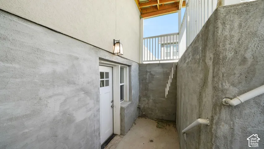 SEPARATE ENTRY TO THE ADU features custom wide steps, a white paneled door w/decorative window