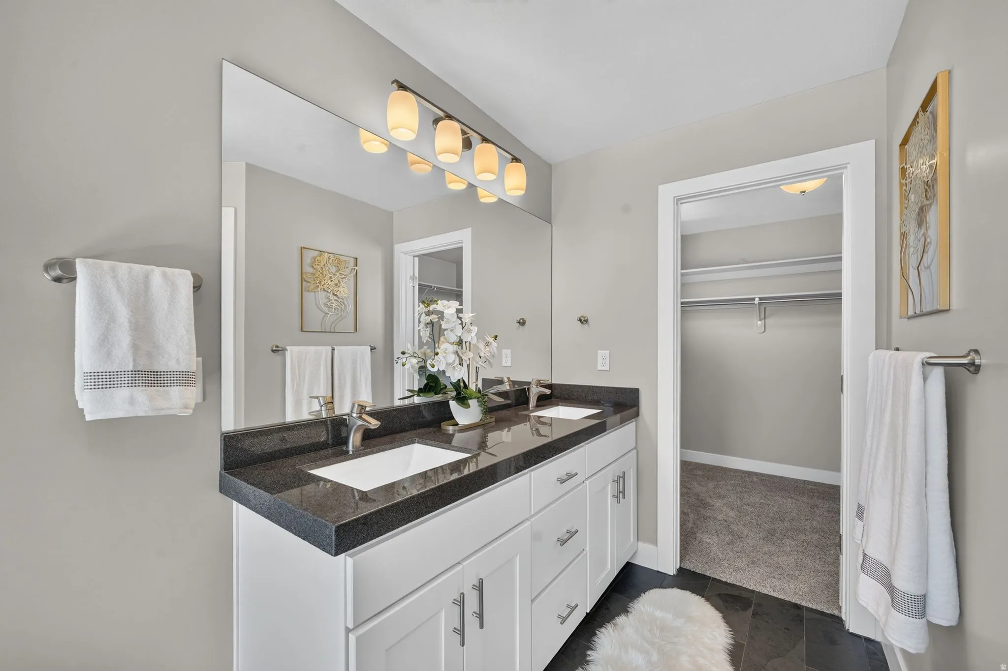 Double vanity with dark countertop and undermount sinks