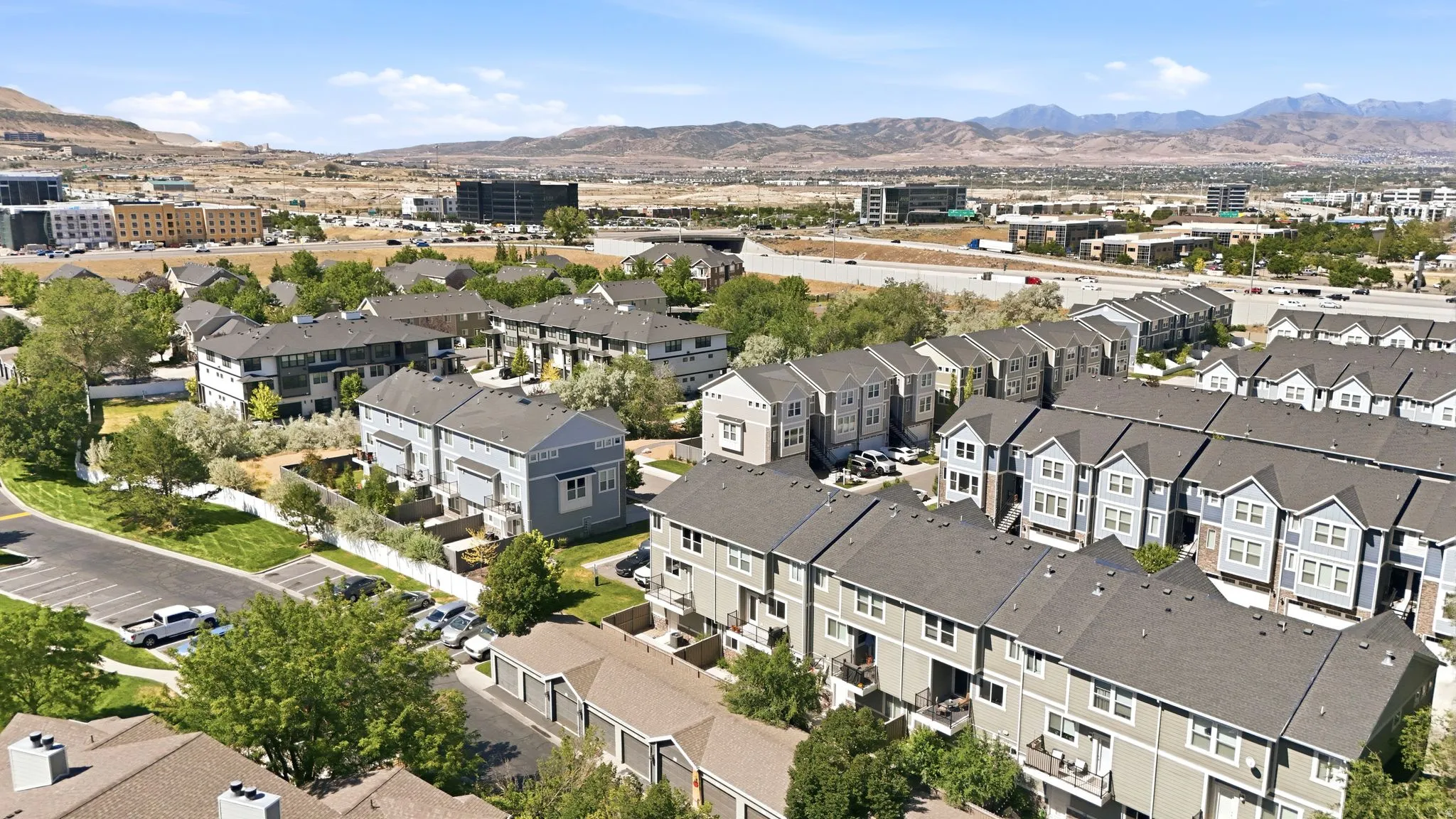 Expansive aerial perspective showcasing a residential community with contemporary townhome-style residences