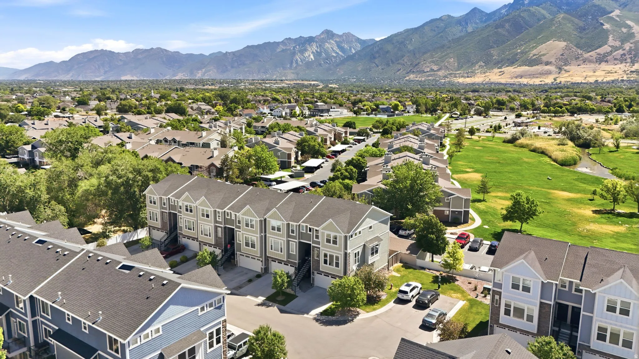 Townhome community featuring multi-story residences with attached garages and pitched roofs