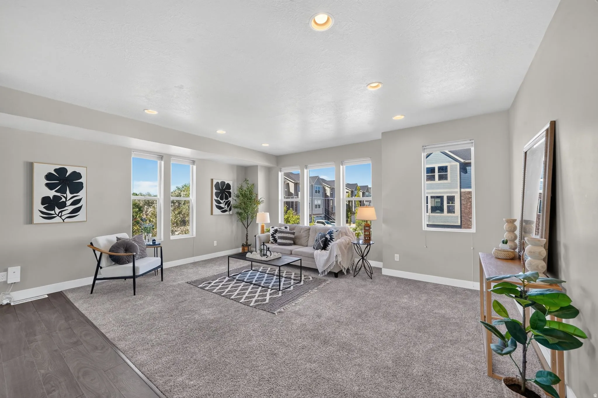 Spacious living area featuring light gray walls and recessed lighting