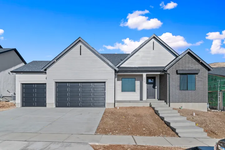 Modern facade featuring a combination of light-colored siding and dark brickwork