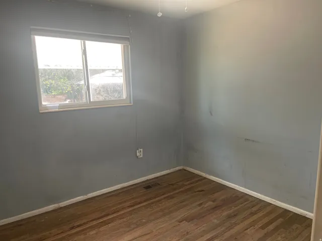 Hardwood flooring, painted walls, window with blinds