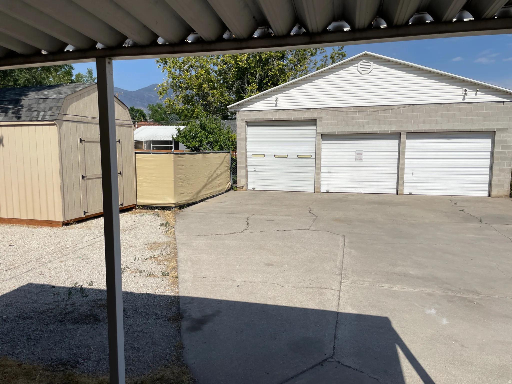 Detached three-car garage with block and siding exterior