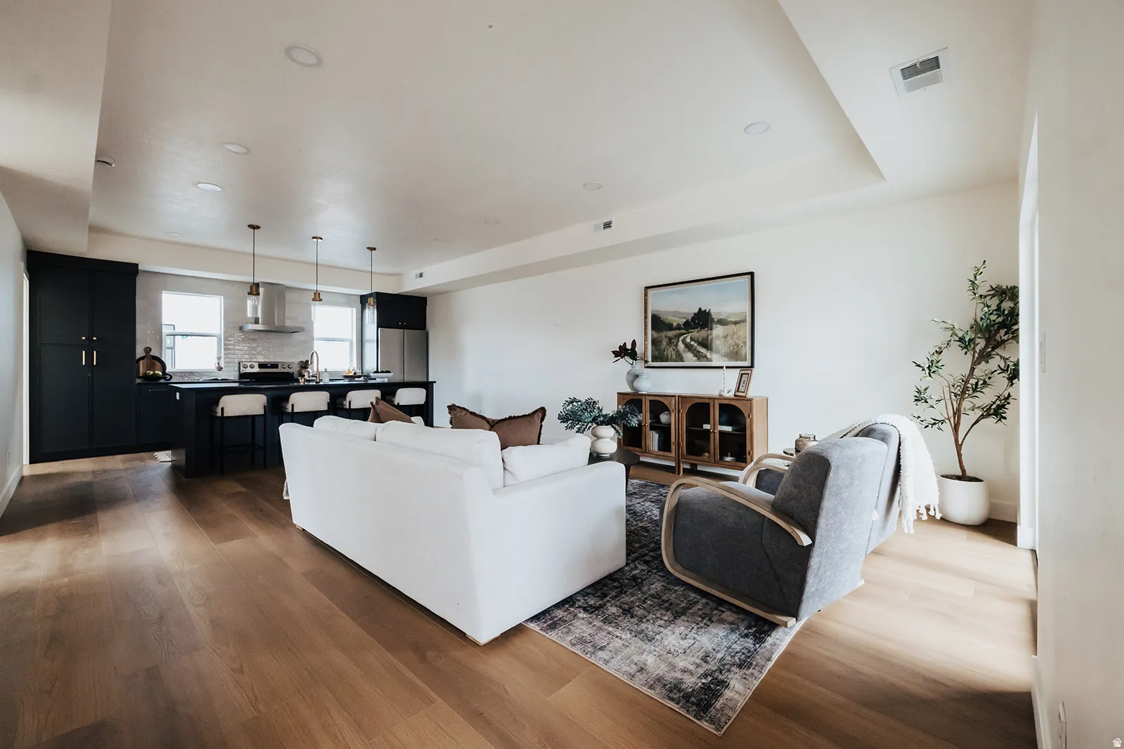 Open-concept living space featuring wood-finish flooring and recessed lighting