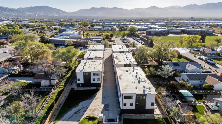 Aerial view showcasing a row of modern residential properties with mountain backdrop
