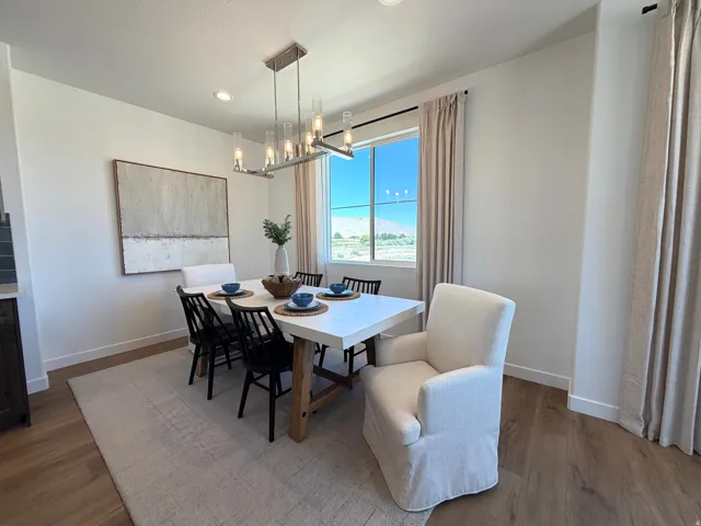 Dining area featuring wood-finish flooring, recessed lighting, and a modern rectangular chandelier