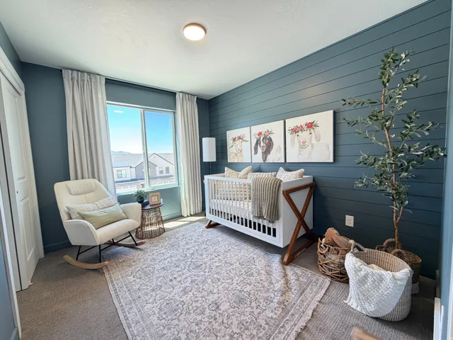 Room featuring a shiplap accent wall, carpet flooring, and a large window with vertical blinds