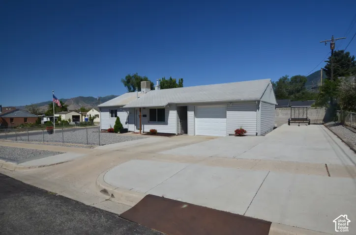 Ranch-style residence featuring white siding and a white shingle roof