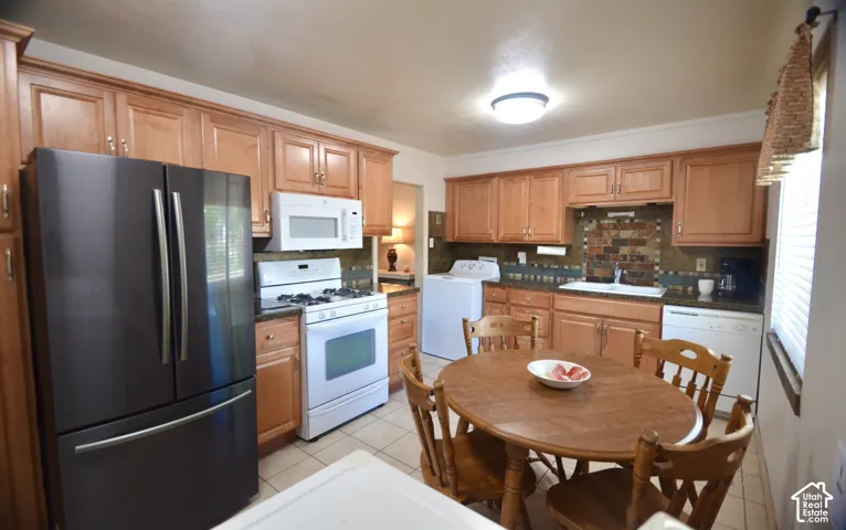 Kitchen featuring wood cabinetry, a decorative tile backsplash, recessed lighting, and tile flooring