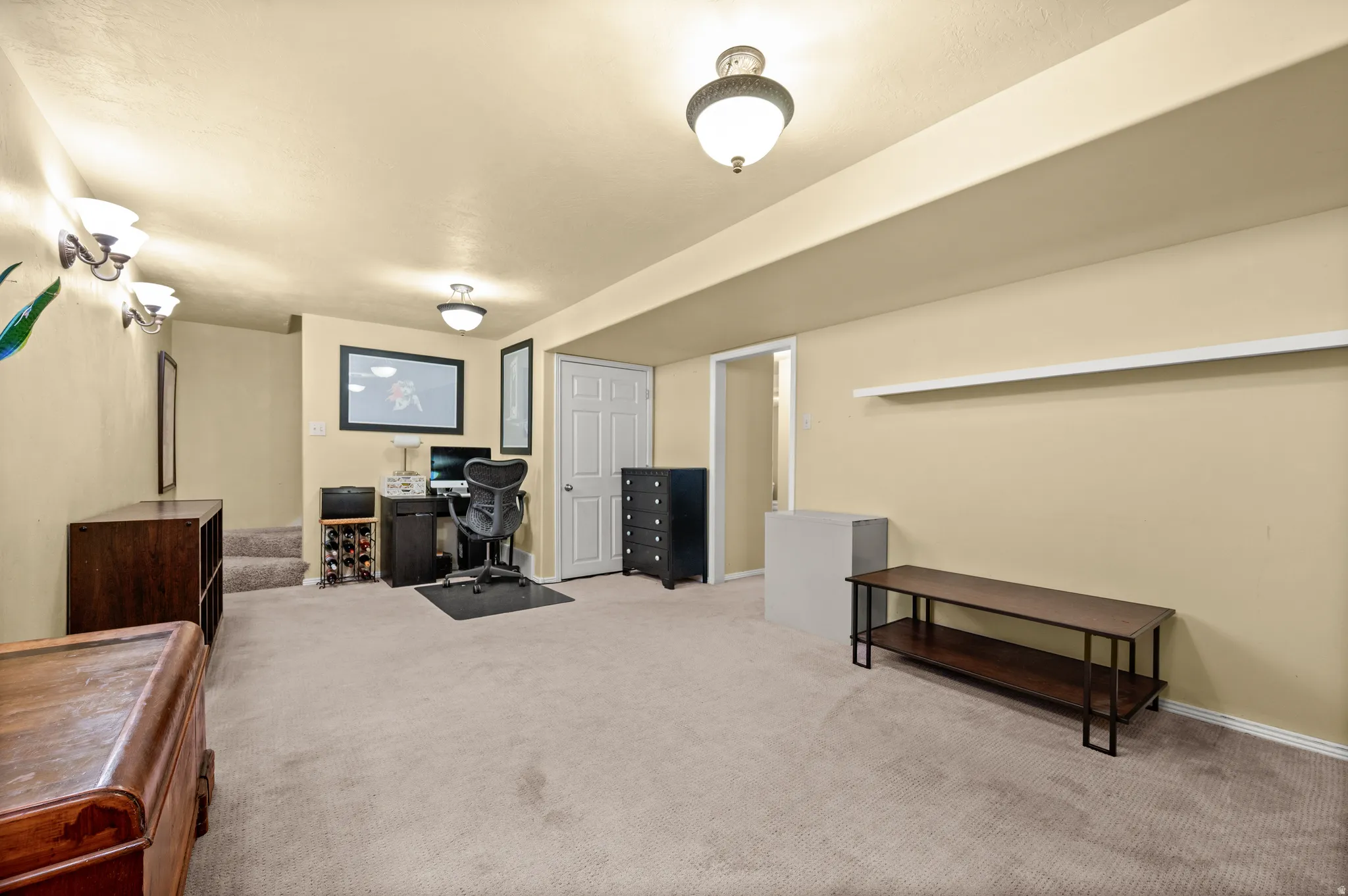 Carpeted room with cream walls and recessed lighting