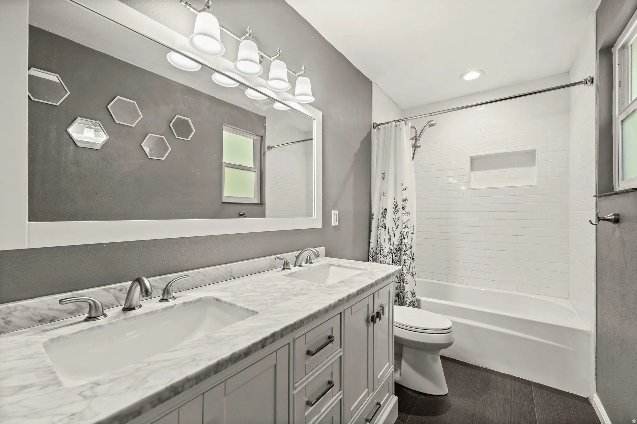 Bathroom featuring a double vanity with stone countertop, undermount sinks, and brushed nickel fixtures