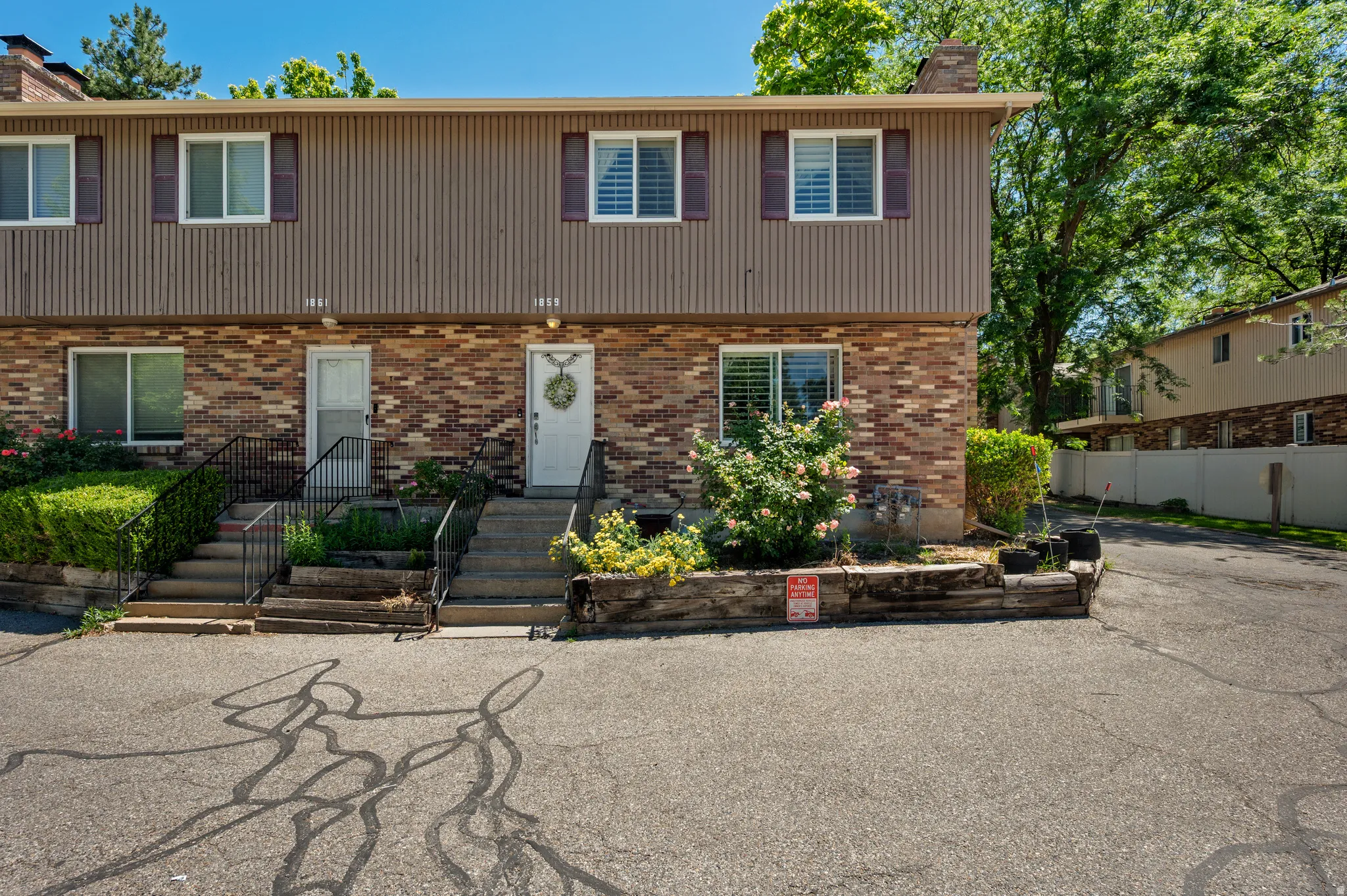 Brick and vertical siding exterior with white front doors