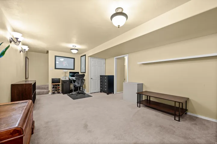 Carpeted room with cream walls and recessed lighting