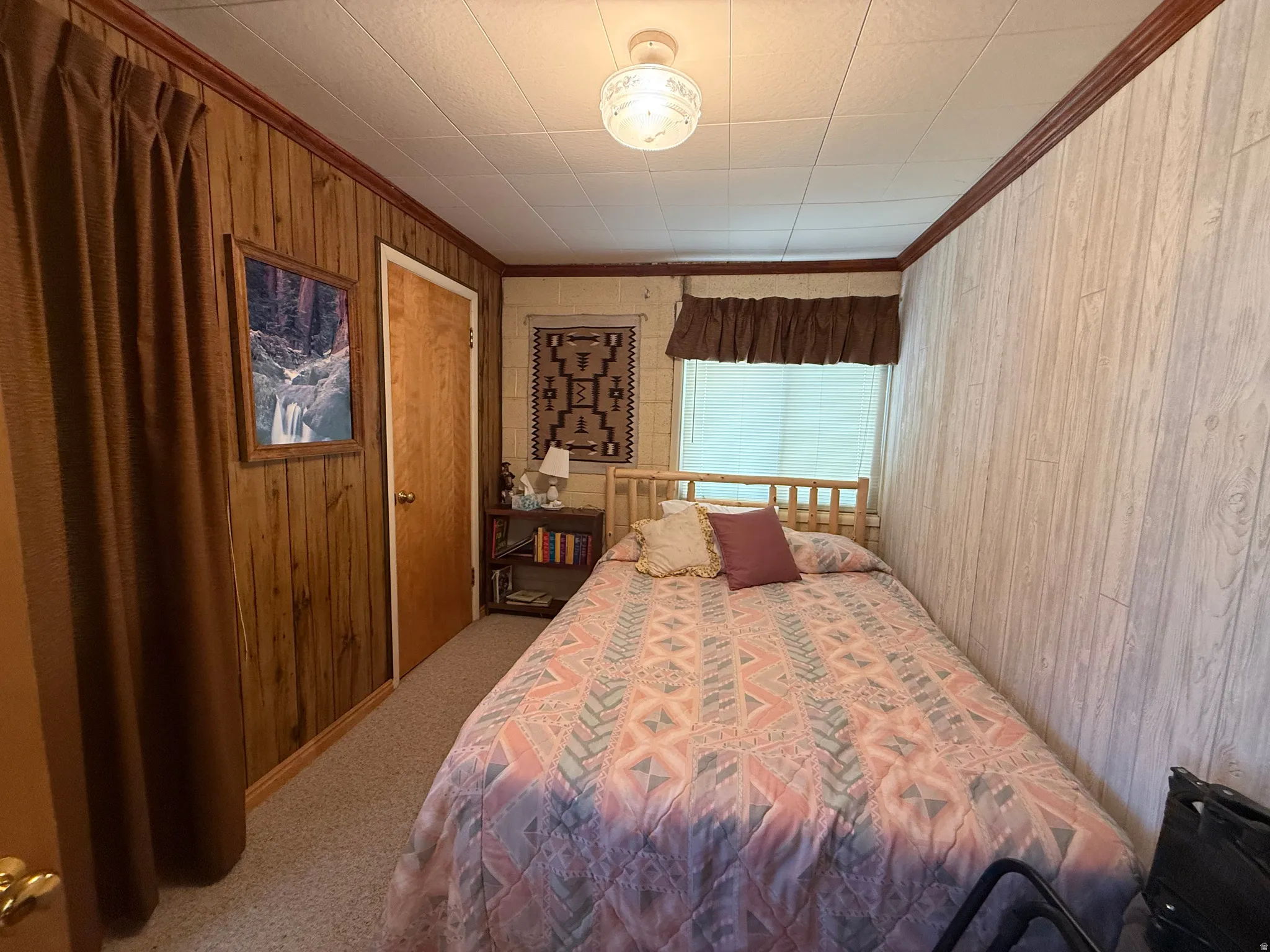 Interior room with wood-paneled walls and a light-colored wood-look accent wall