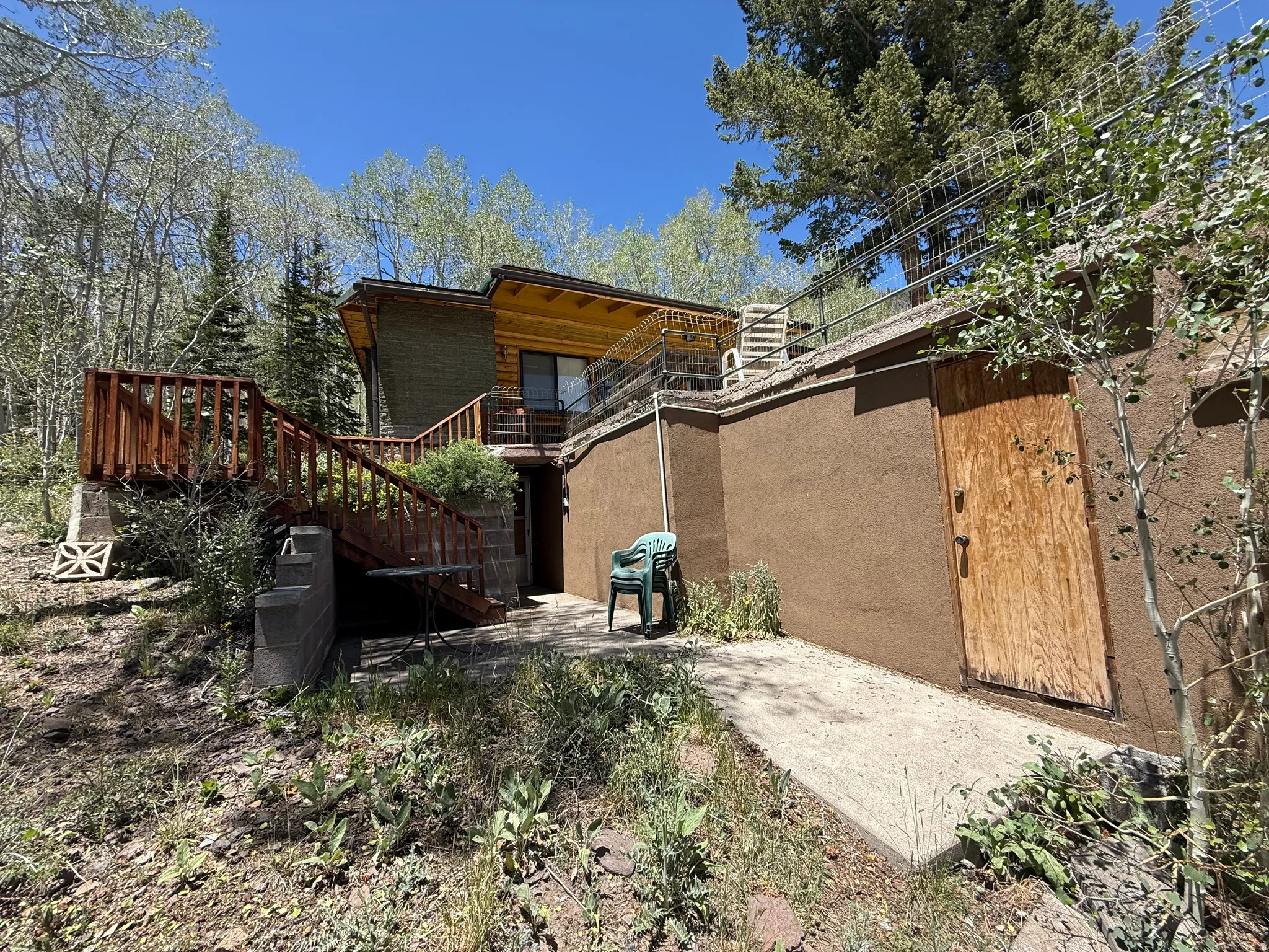 Multi-level exterior with a prominent wooden deck and railing