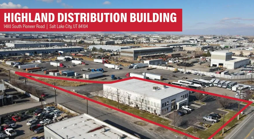 Commercial building featuring a flat roof, multiple large windows, and an asphalt parking lot