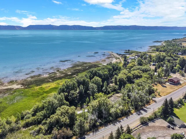 Expansive waterfront with a diverse shoreline, backed by a wooded area