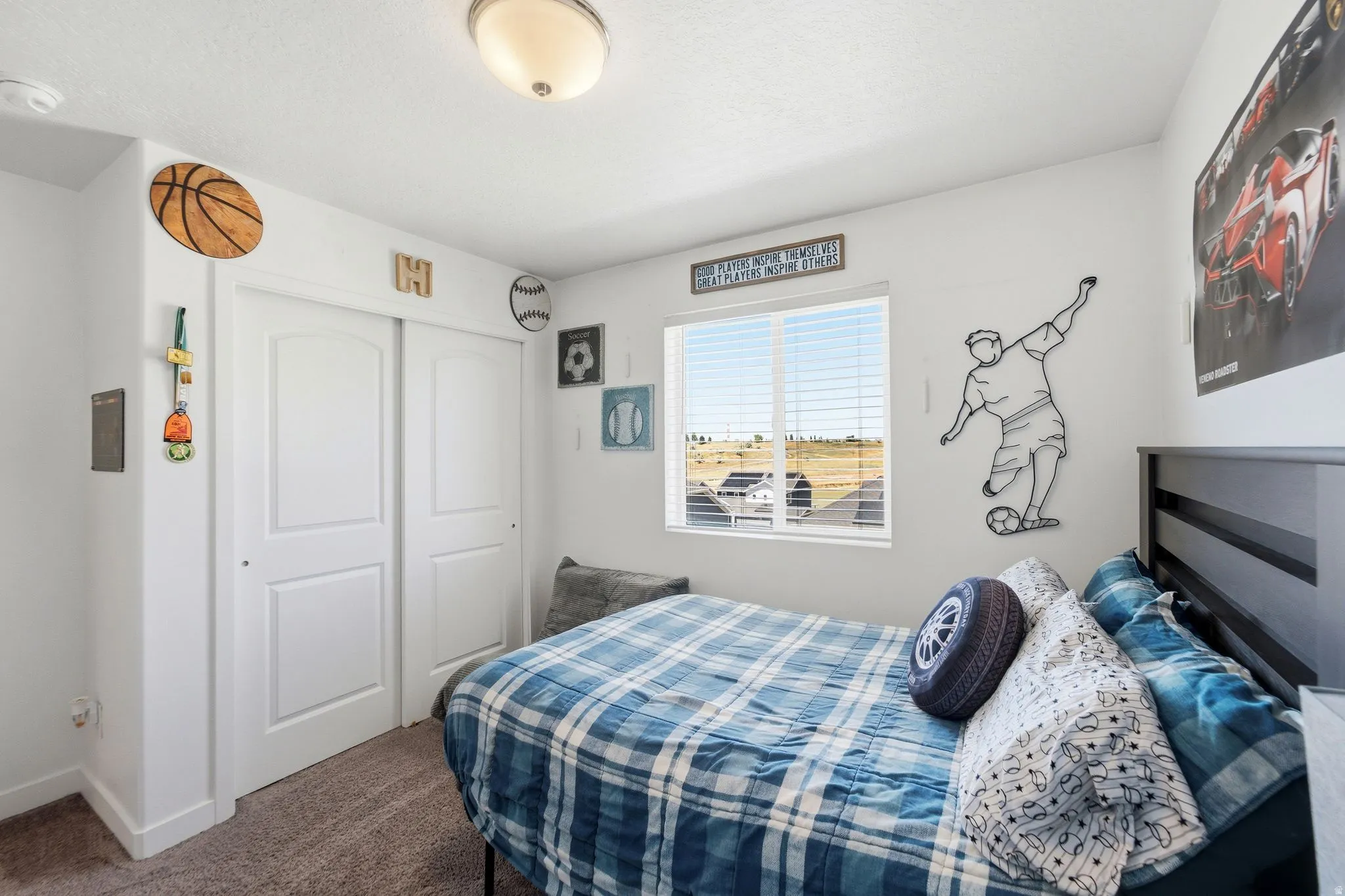 Bedroom with a window featuring horizontal blinds, neutral wall paint, and a semi-flush mount ceiling light