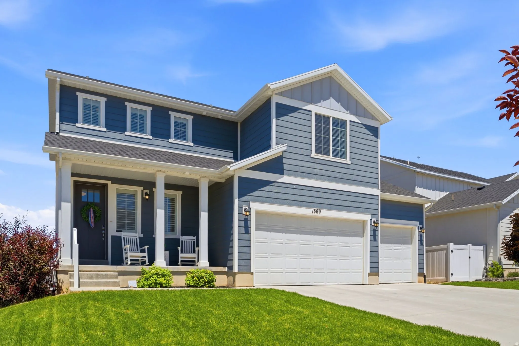 Two-story residence featuring blue siding with white trim accents