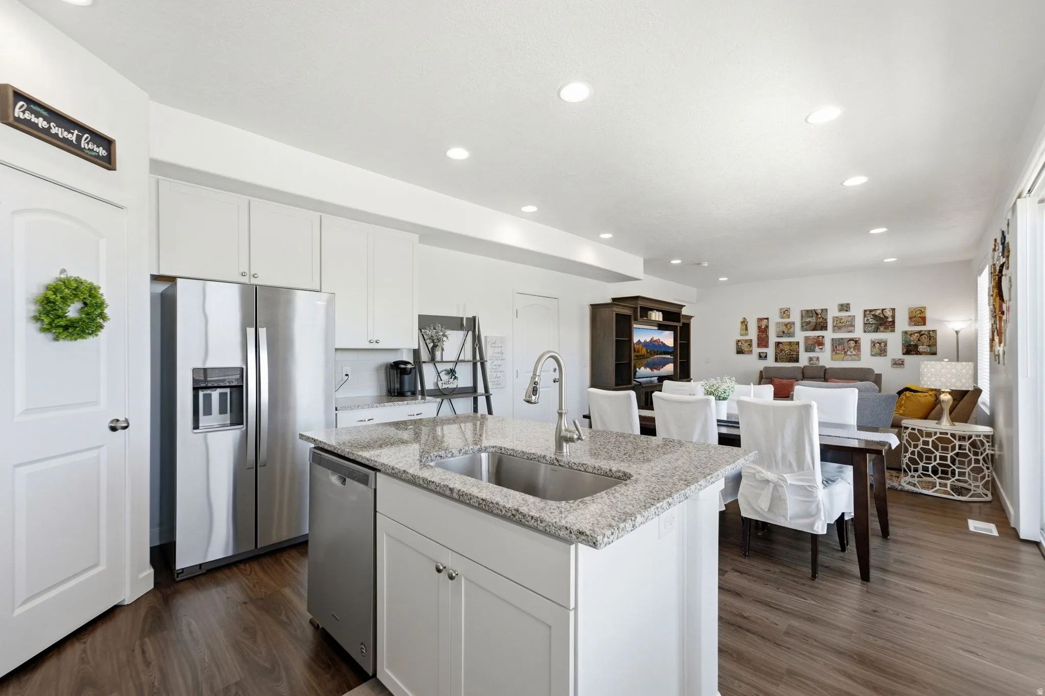 Kitchen island featuring a double-basin stainless steel sink and granite countertop