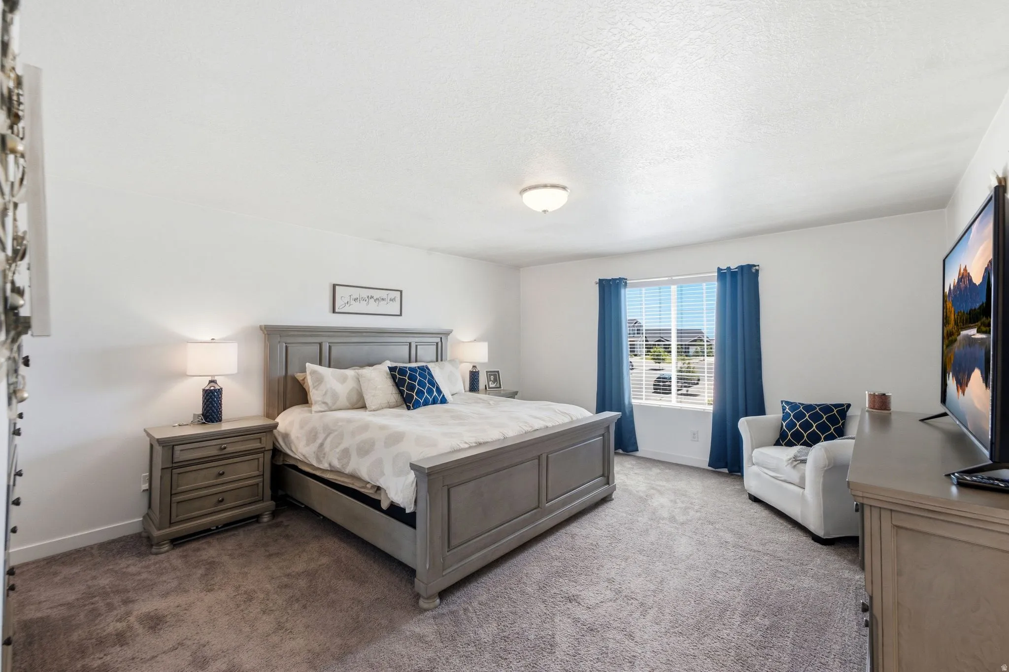 Spacious room featuring neutral carpeting and white walls
