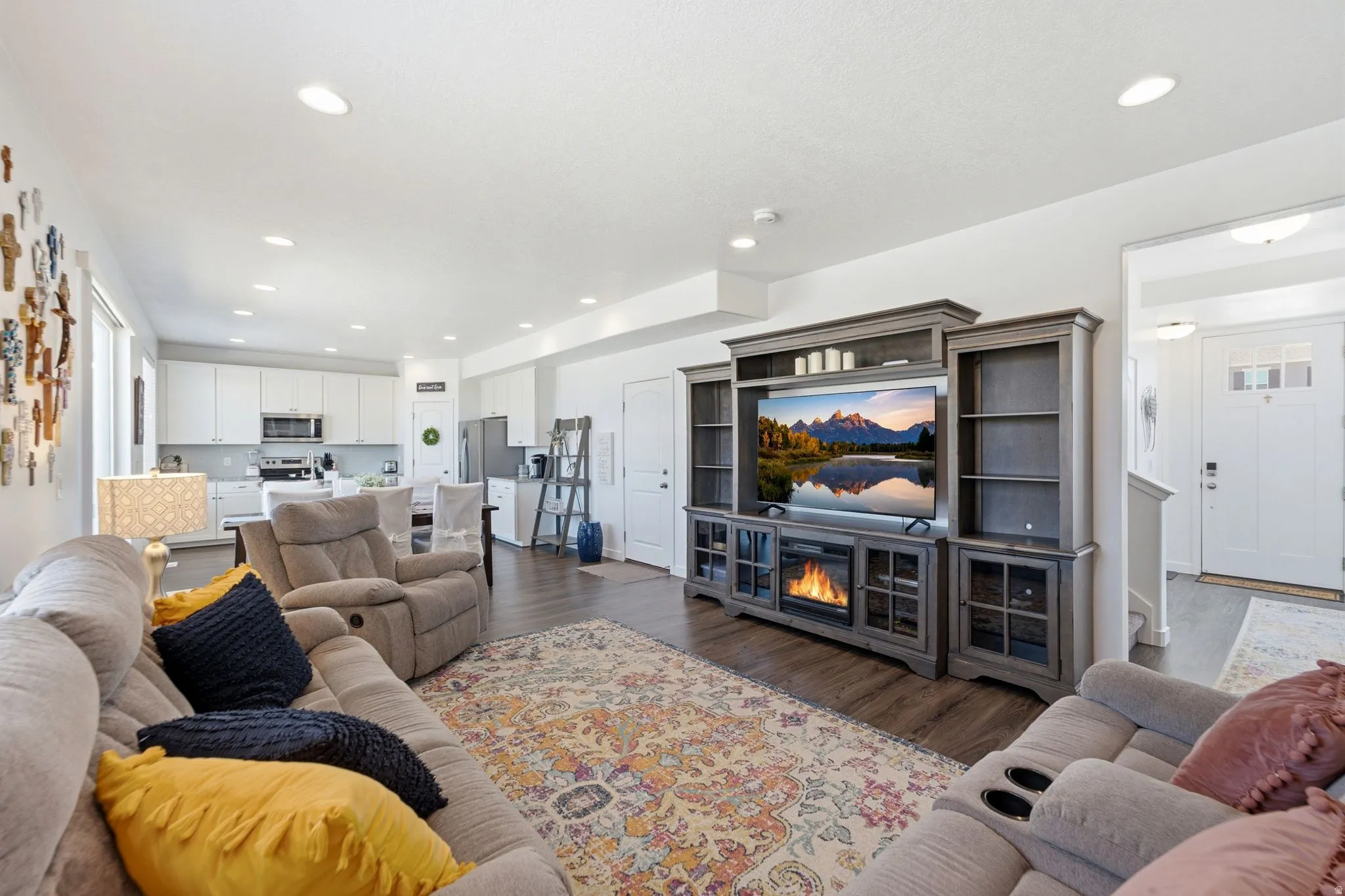 Open-concept living area featuring wood-finish flooring and recessed lighting