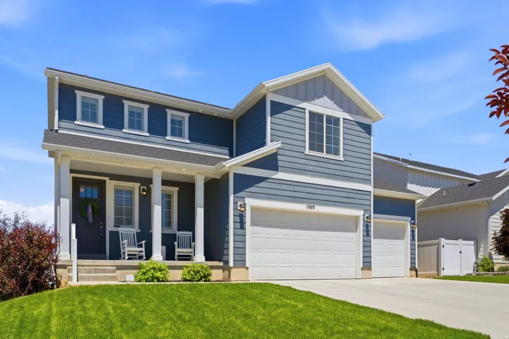 Two-story residence featuring blue siding with white trim accents