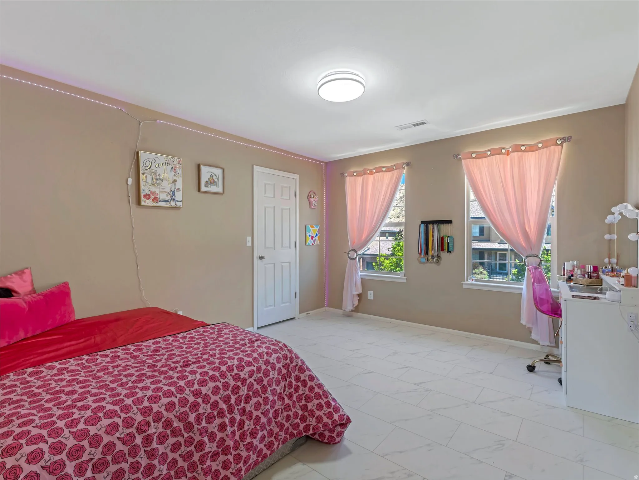 Spacious room featuring light-toned walls, white trim, and light-colored tile flooring