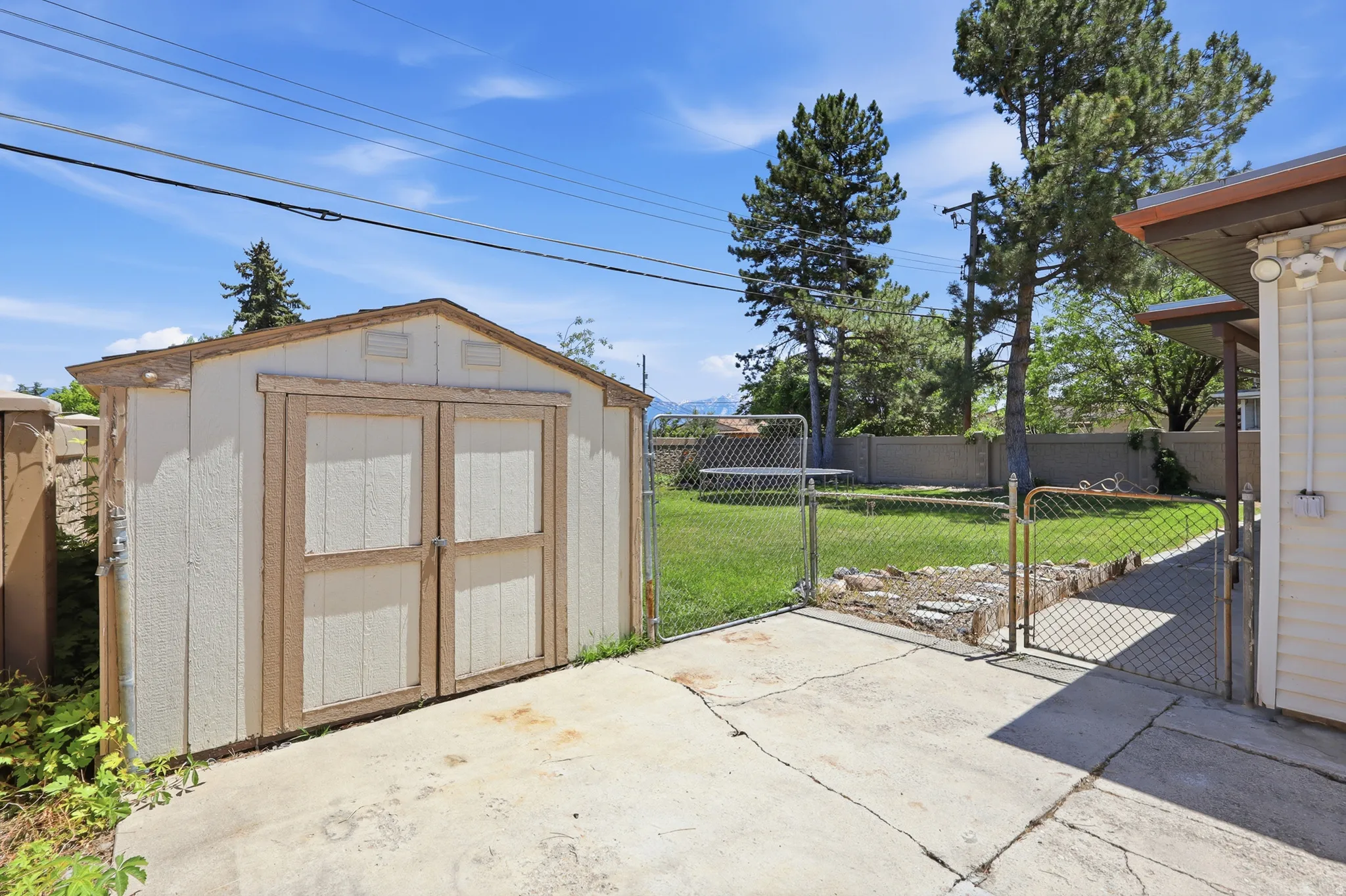 Detached storage shed with double doors, set on a concrete pad
