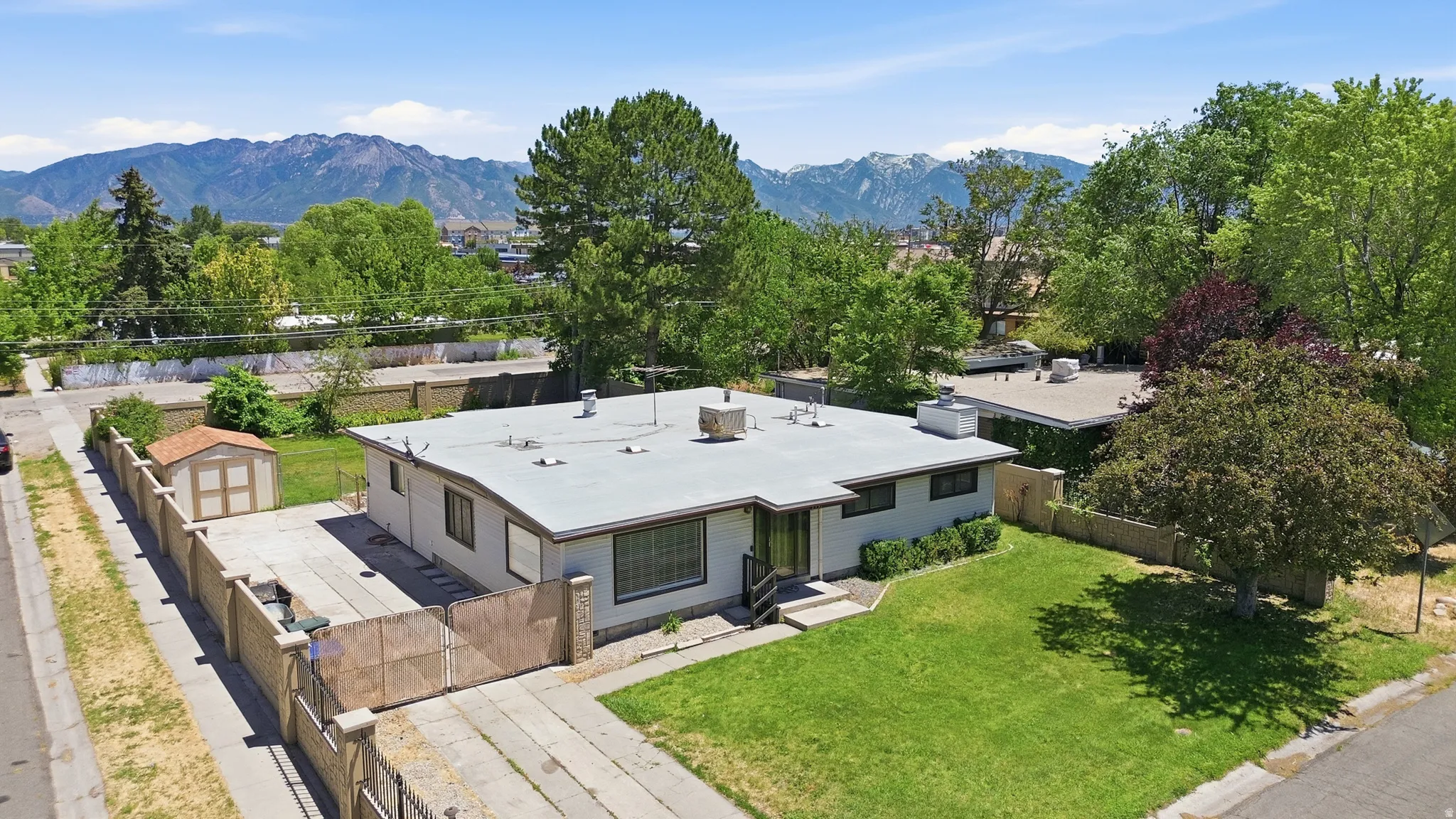 Single-story residence featuring a flat roofline and light-toned exterior siding