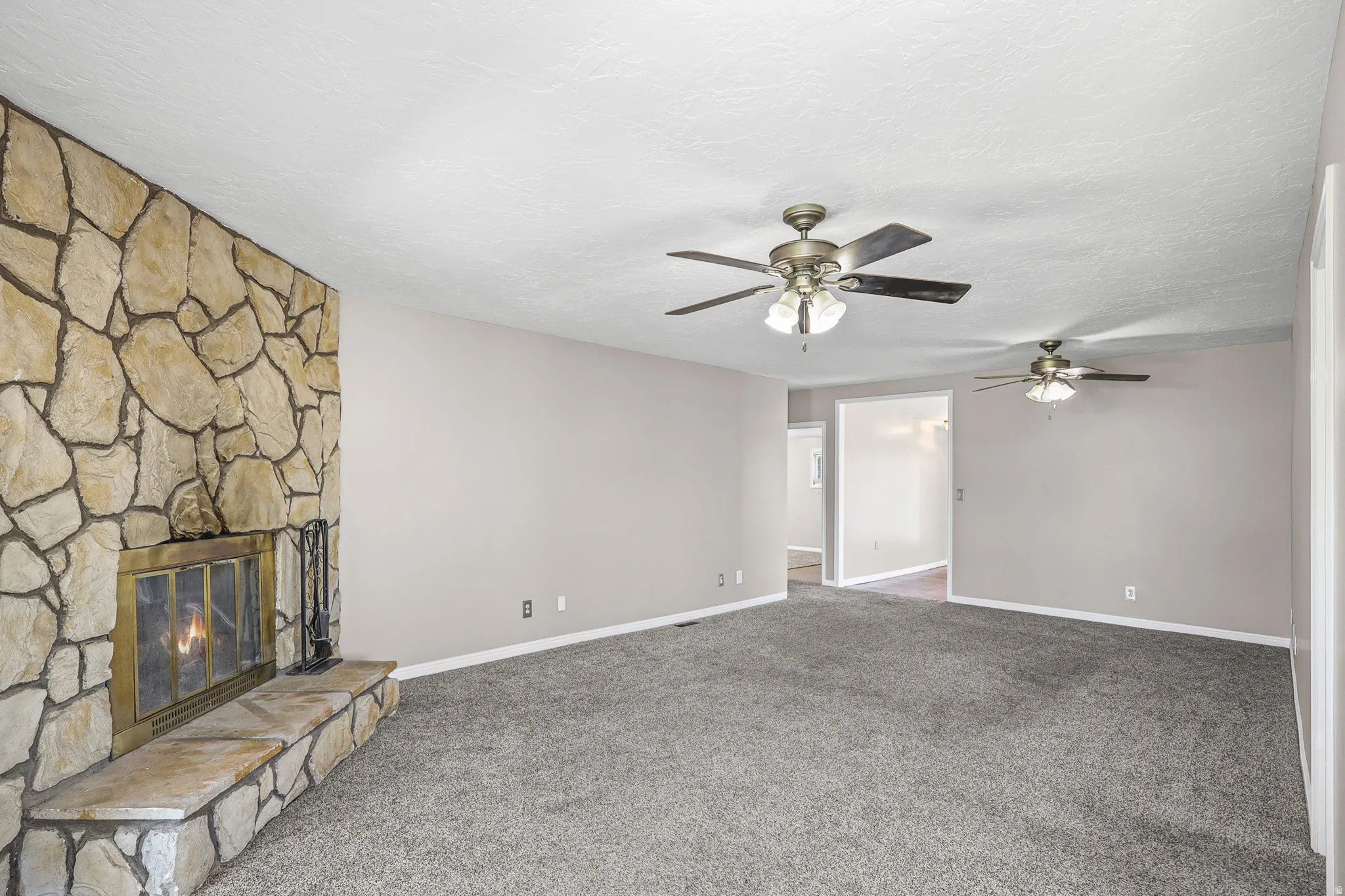 Stone-clad fireplace with a brass firebox and hearth