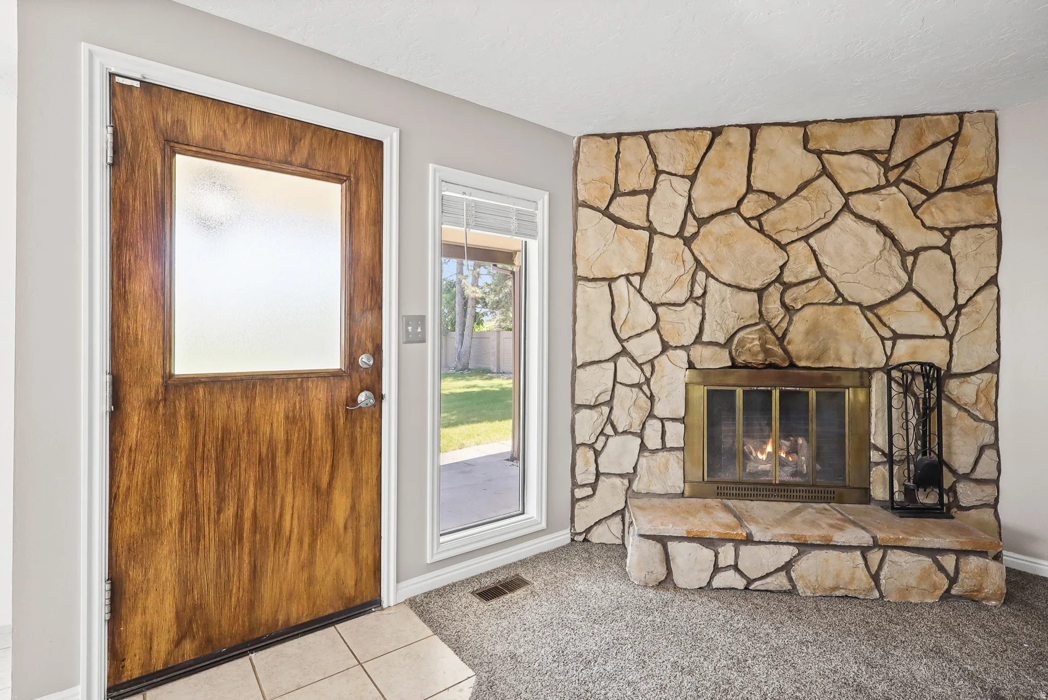 Stone-clad fireplace with a brass firebox and hearth