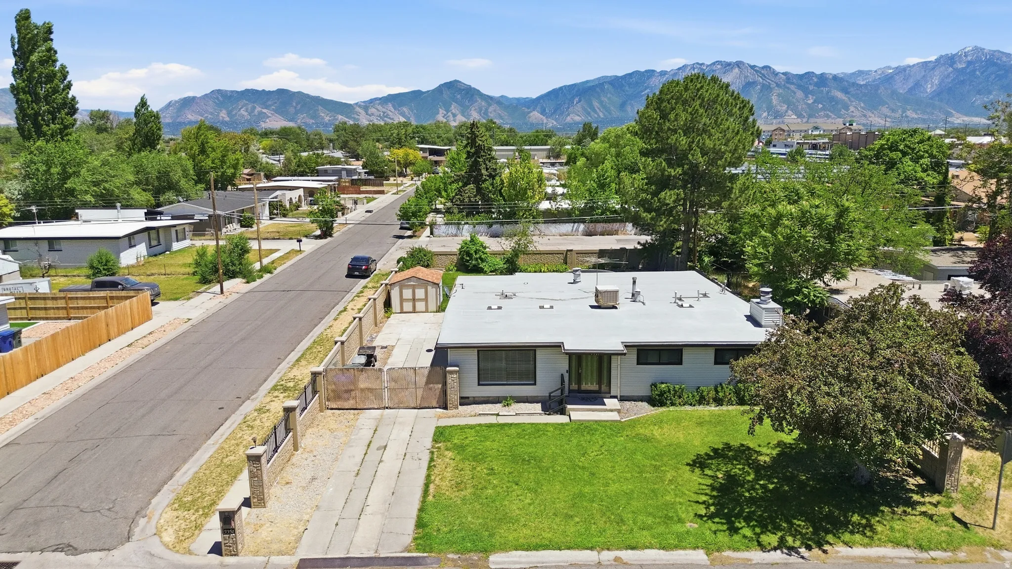 Modern ranch-style residence featuring a flat roofline and integrated carport
