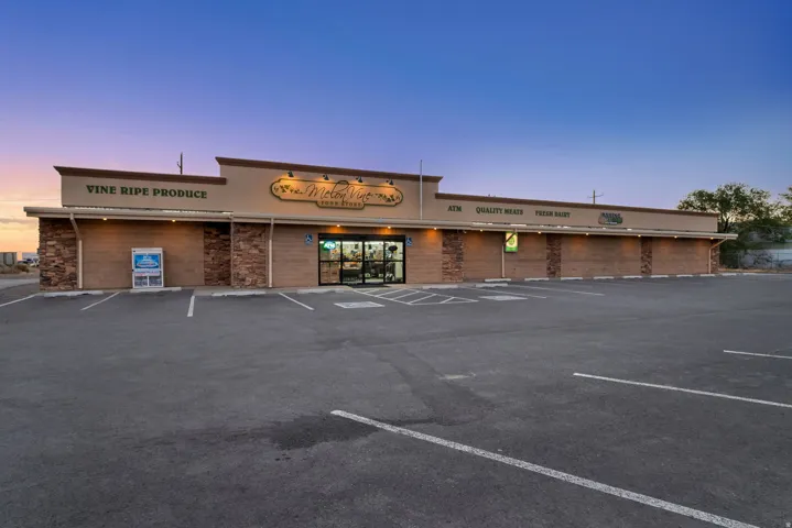 Commercial building with a spacious asphalt parking lot and stone facade accents