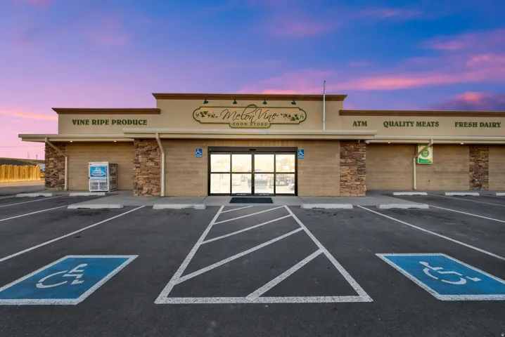Commercial storefront featuring a neutral-toned facade with stone veneer accents