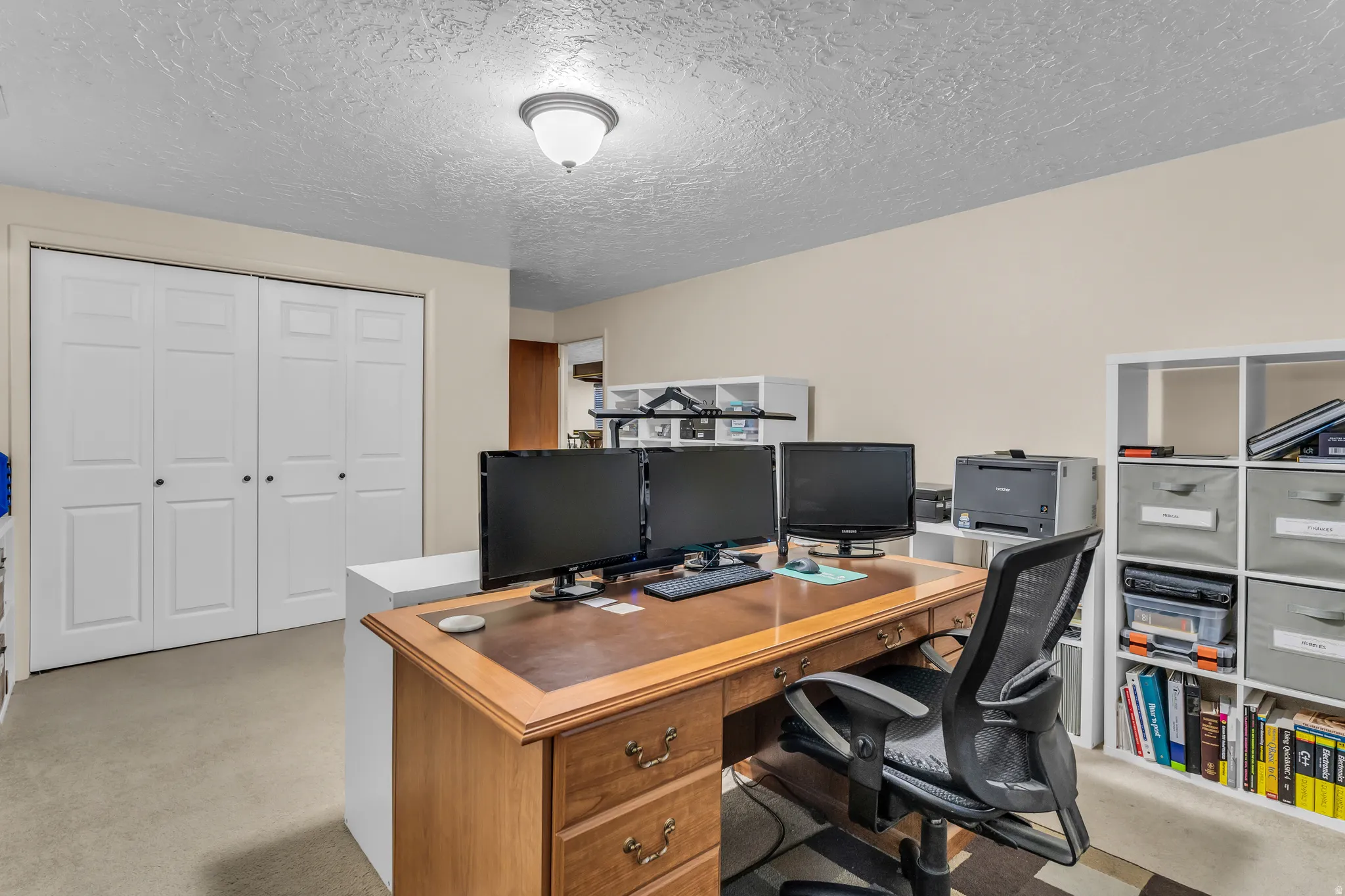 Versatile interior space featuring light-colored walls and carpeted flooring