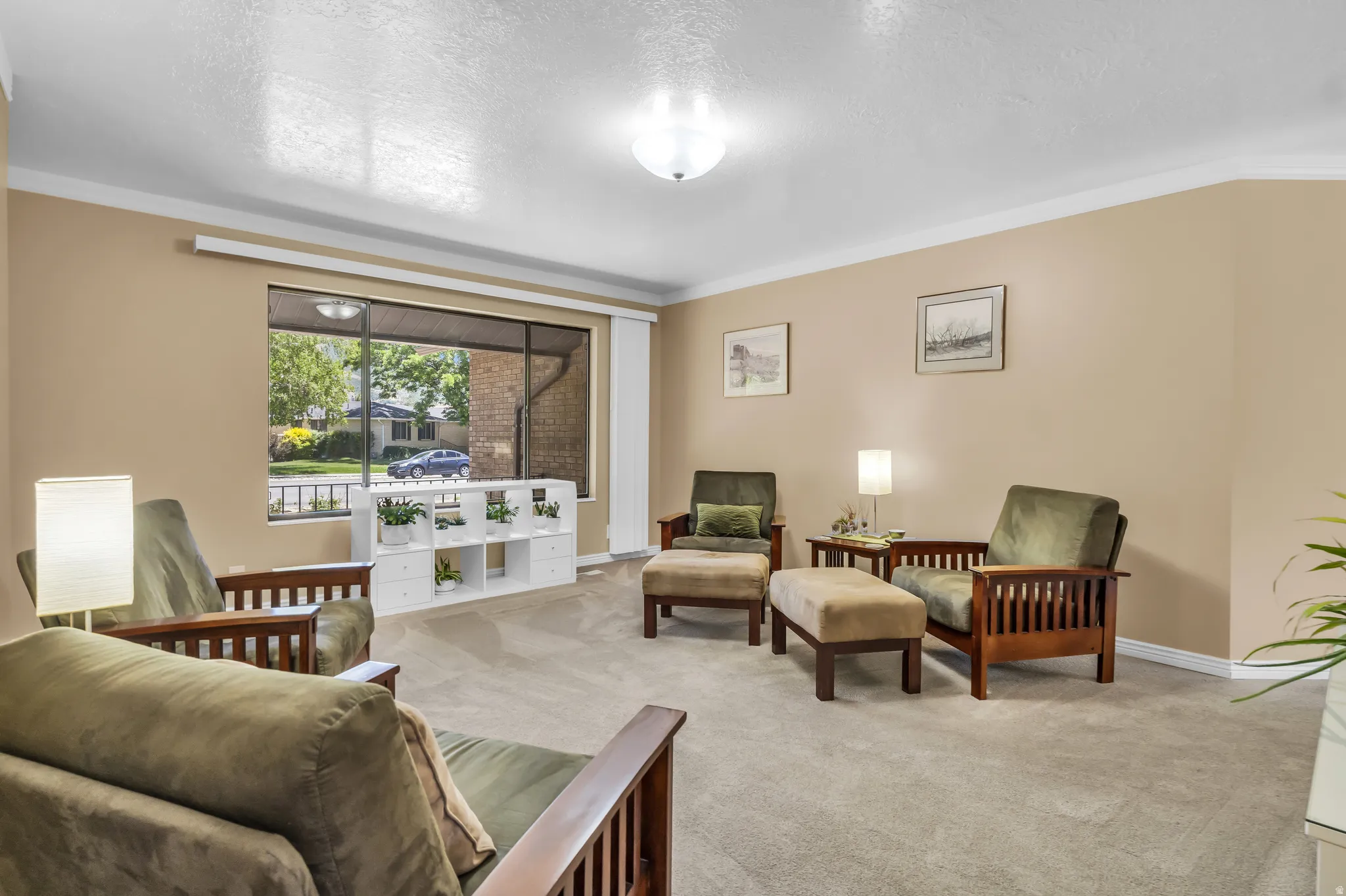 Spacious room featuring a large picture window, crown molding, neutral wall color, and recessed ceiling lighting