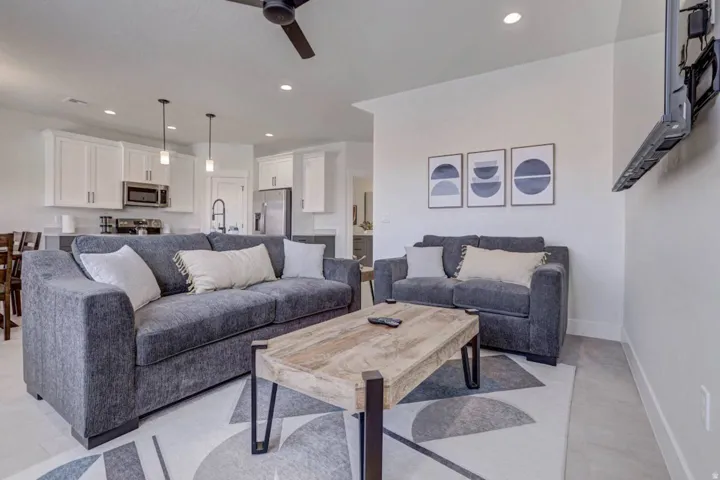 Open-concept living space featuring recessed lighting, a ceiling fan, and light-toned flooring